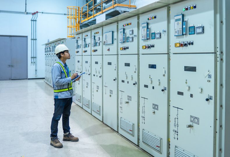 Engineer working and check status switchgear electrical energy distribution at substation room, maintenance engineers inspect relay protection system electric concept, Medium voltage switchgear